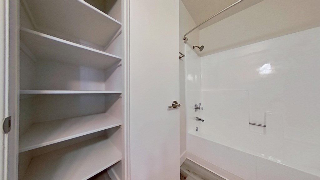 A white refrigerator with its door open.