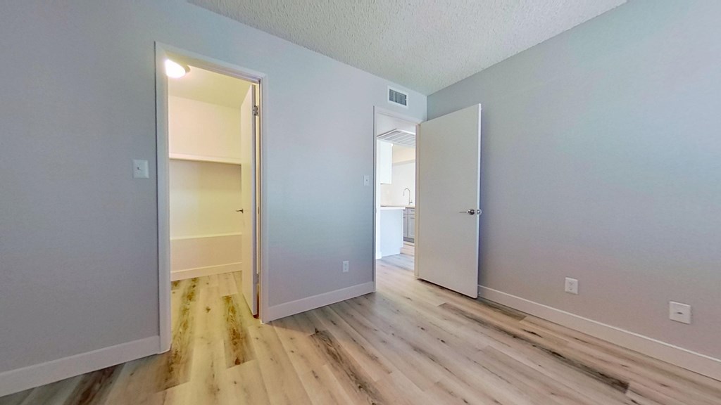 A room with a white door and a white wall.