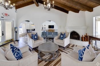 A living room with a fireplace and a couch. at The Viridian Apartments, Scottsdale 85250