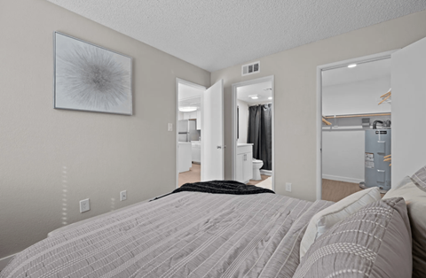 A bedroom with a large bed and a mirror on the wall  at Tides on McDowell, Phoenix, AZ