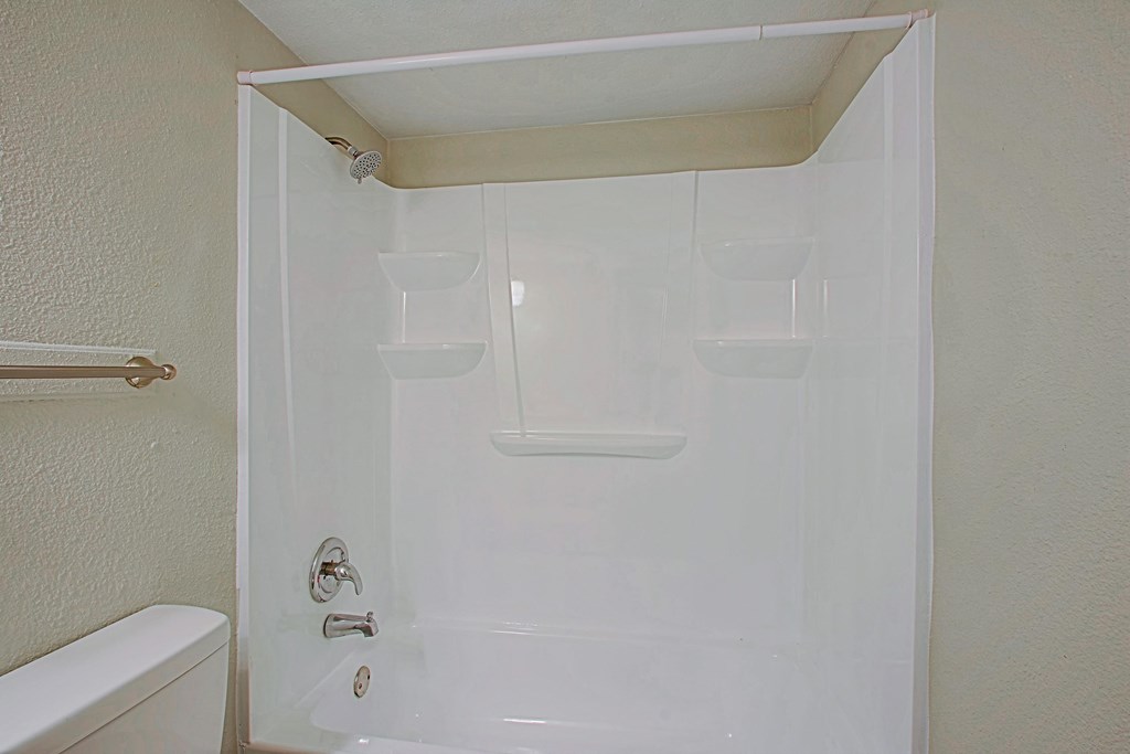 a bathroom with a shower and a toilet in it