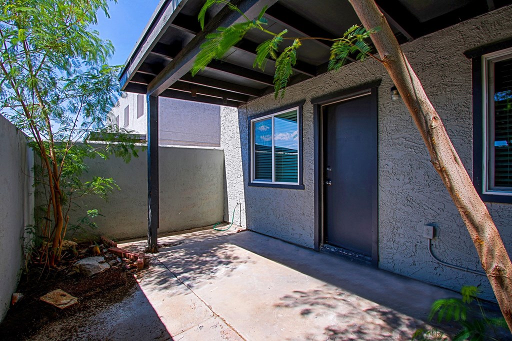 the front entrance to a house with a blue door
