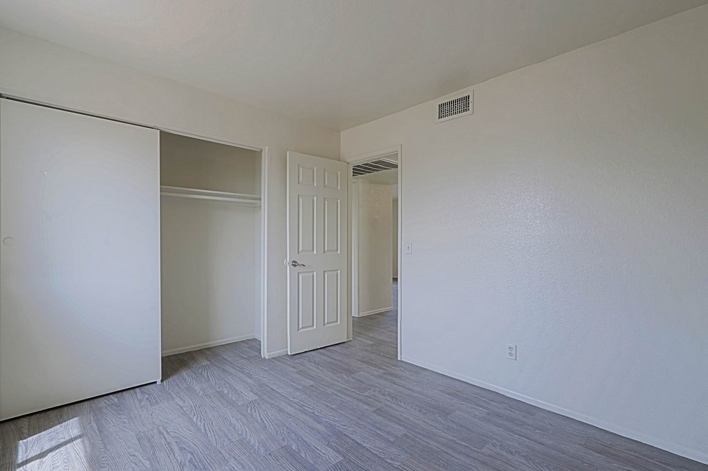 A room with a white door and a white wall.