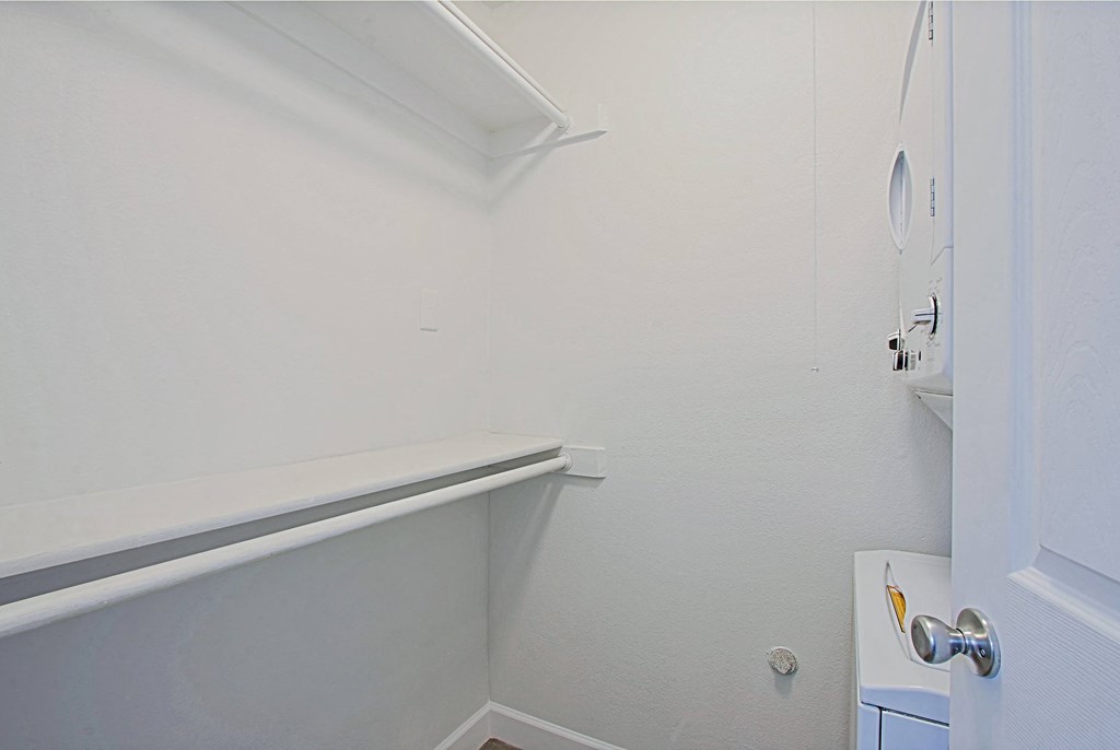 a small bathroom with white walls and a rail in the corner