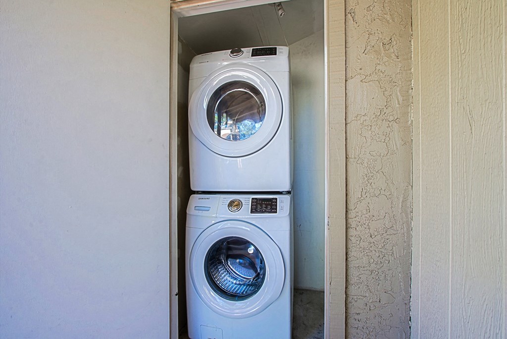 a washing machine and a dryer in a small closet