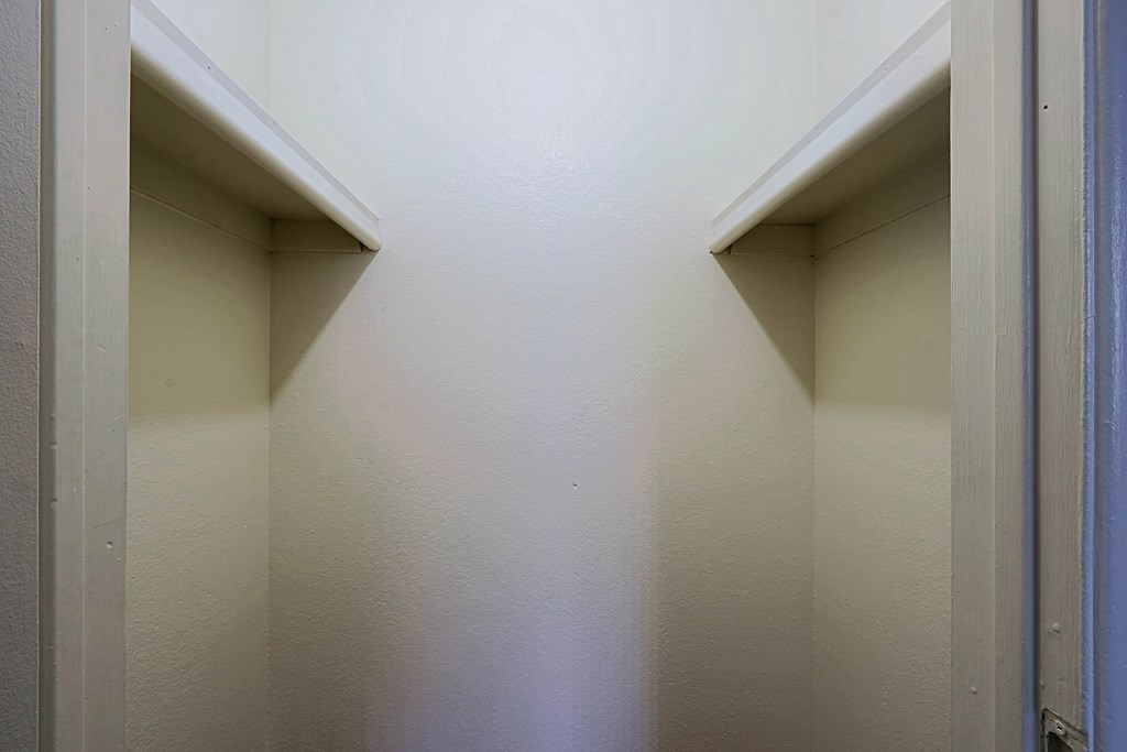 A white hallway with two doors on either side.