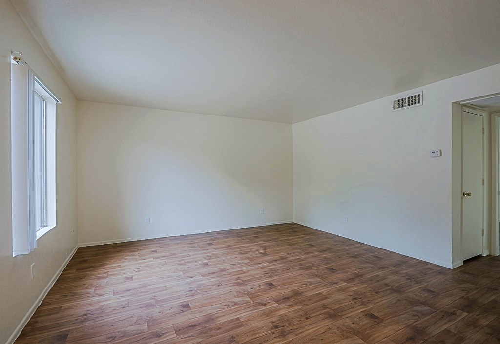 A room with wooden floors and white walls.