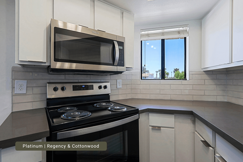 A modern kitchen with a stainless steel oven and microwave.