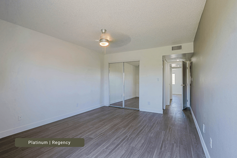 A room with a wooden floor and a white ceiling.