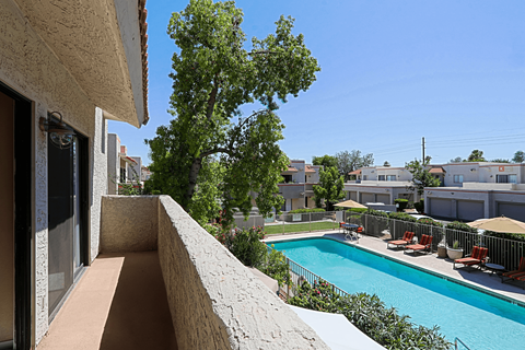 A pool area with a view of a residential area.