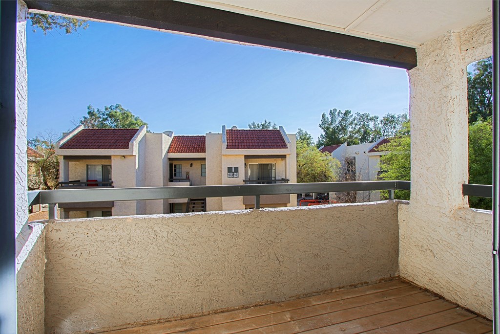 a balcony with a view of houses and trees