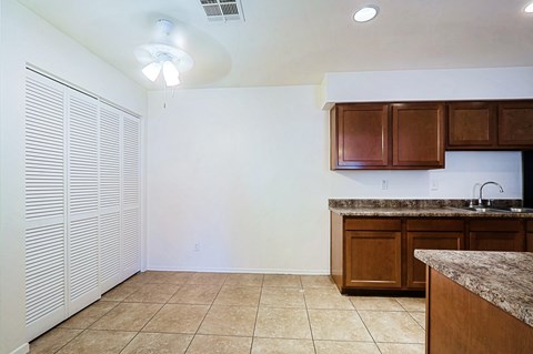 A kitchen with brown cabinets and a counter top.