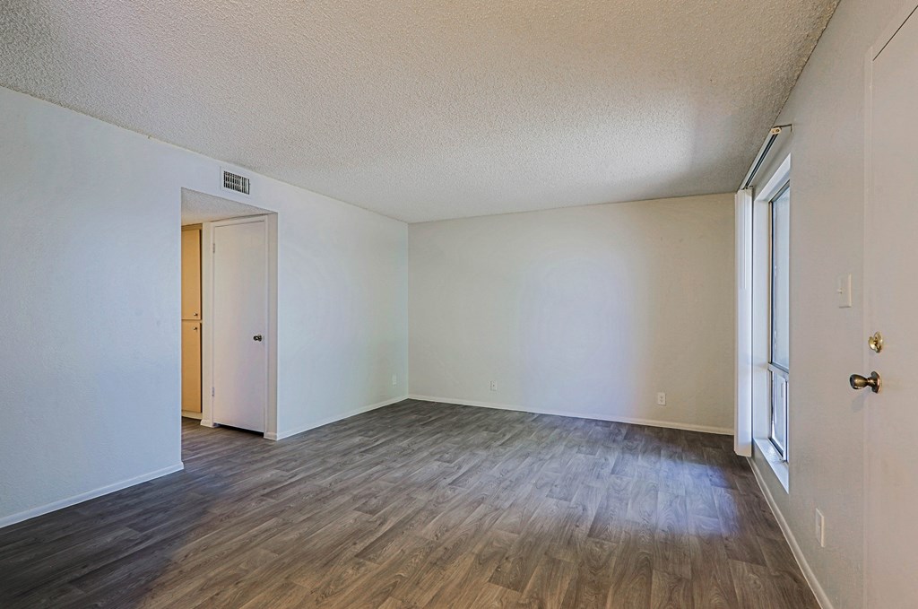 A room with a wooden floor and white walls.
