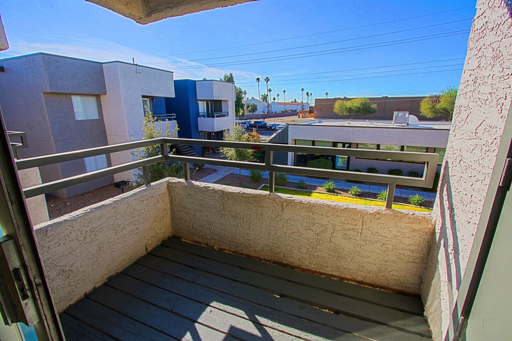 a balcony with a view of a building and a street