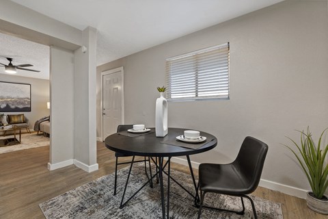 A dining room with a table set for two.