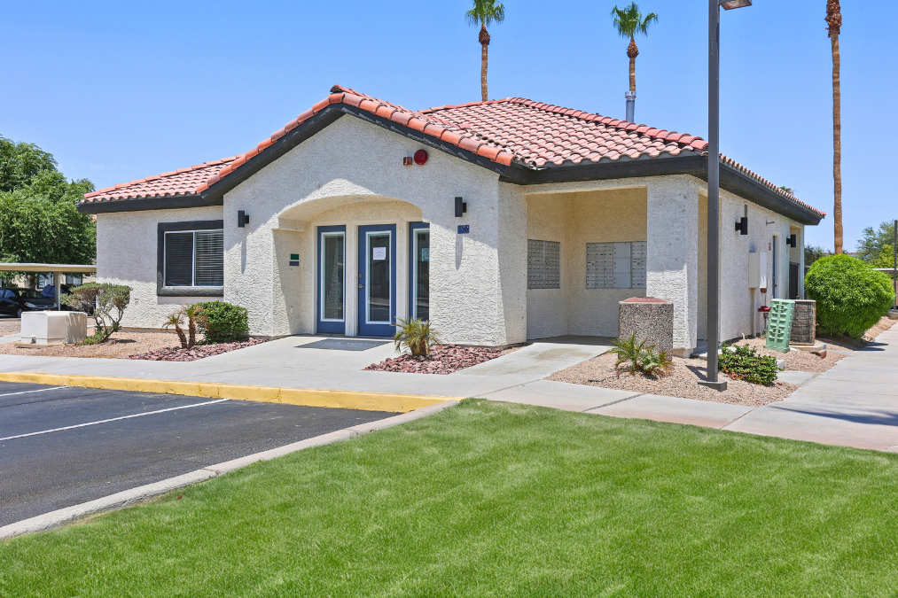A small house with a red tile roof and a blue door.