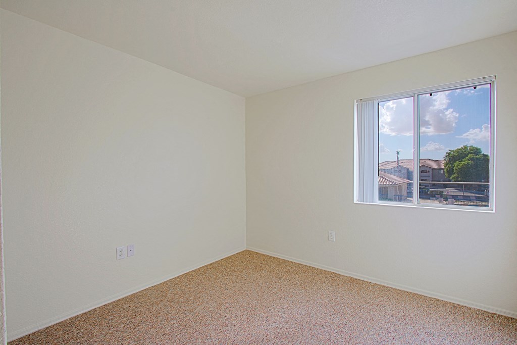 Empty room with a window showing a view of the outside.