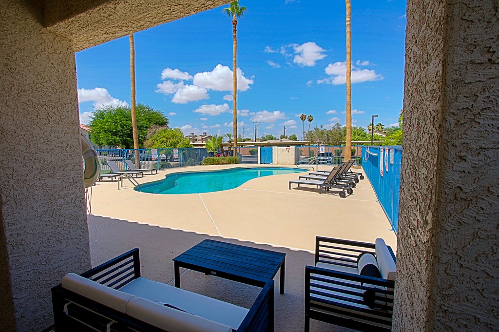 A pool area with a table and chairs.