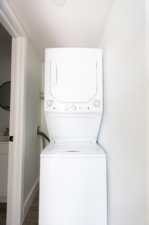 White Stacked Washer in Dryer in Closet of Apartment