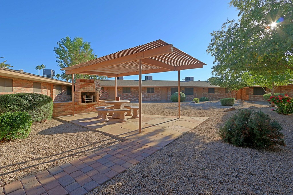 a patio with a picnic table and a pergola