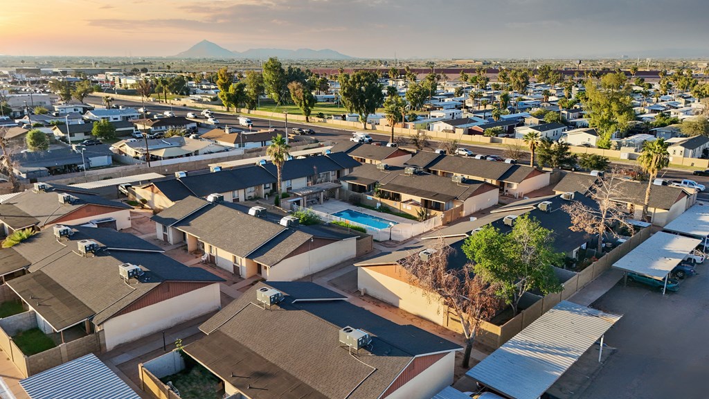 A residential area with houses and a mountain in the background.