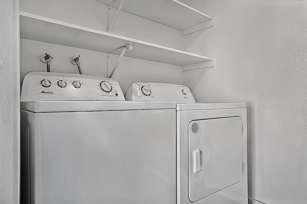 A white washing machine with the door open.