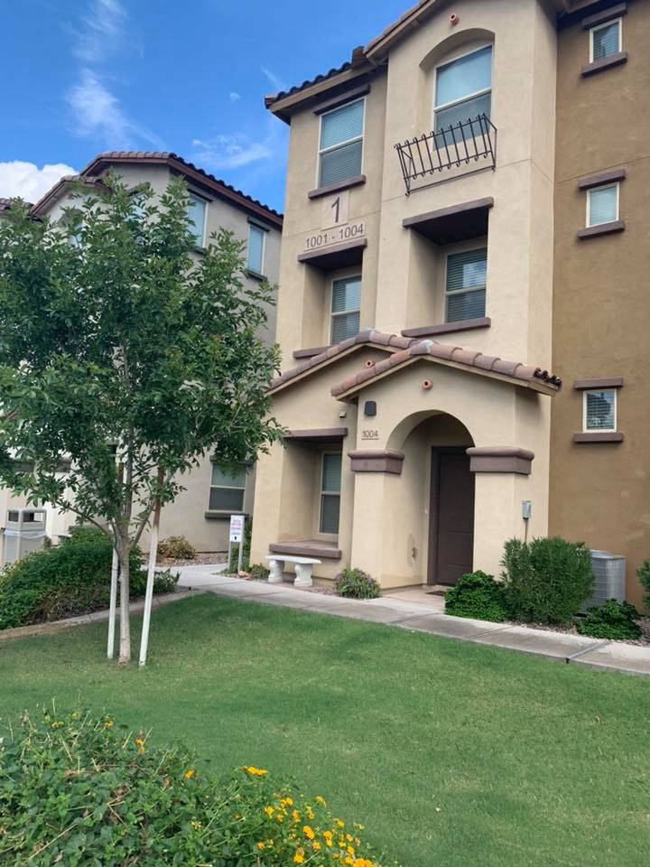 a building with a lawn and trees in front of it