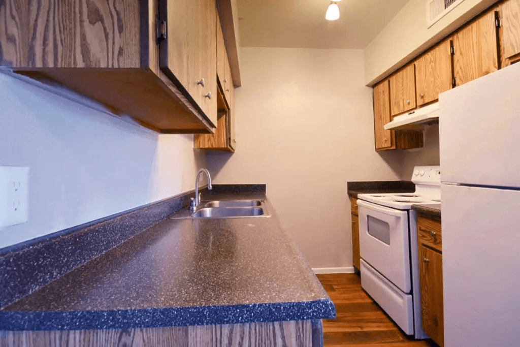 A kitchen with a white refrigerator and a white oven at Gilbert Square Apartments, Mesa, AZ