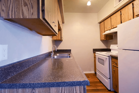 A kitchen with a white refrigerator and a white oven.