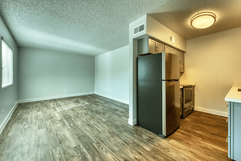 A kitchen area with a refrigerator and oven.