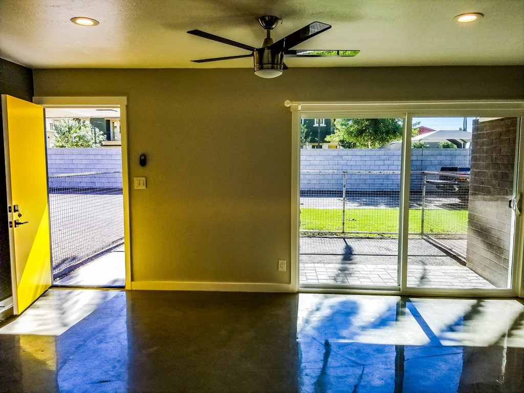 a living room with a sliding glass door and a view of a yard