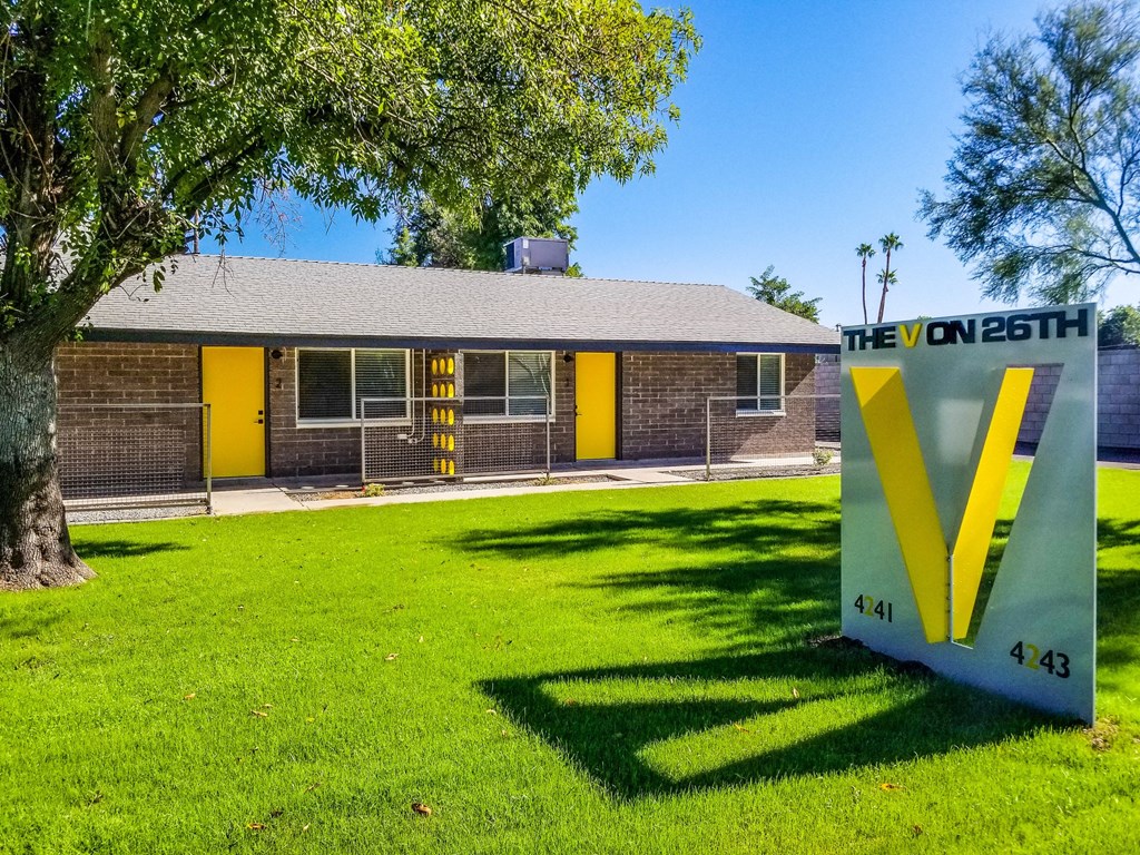 a house with a v sign in front of it