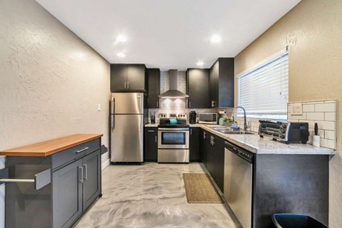 a kitchen with stainless steel appliances and a counter top