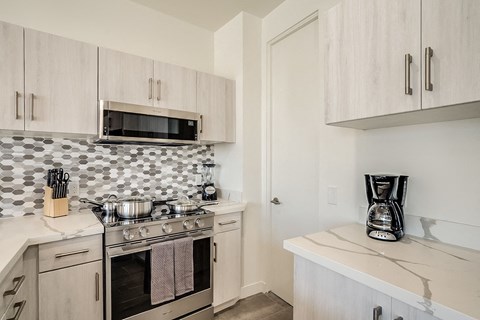 a kitchen with a stove and microwave and a counter top