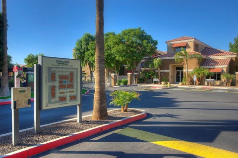 a sign on the side of a street in front of a building