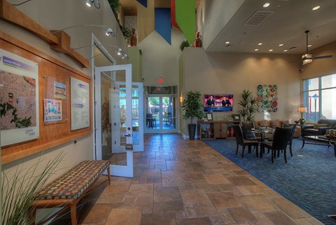the lobby of a building with a table and chairs