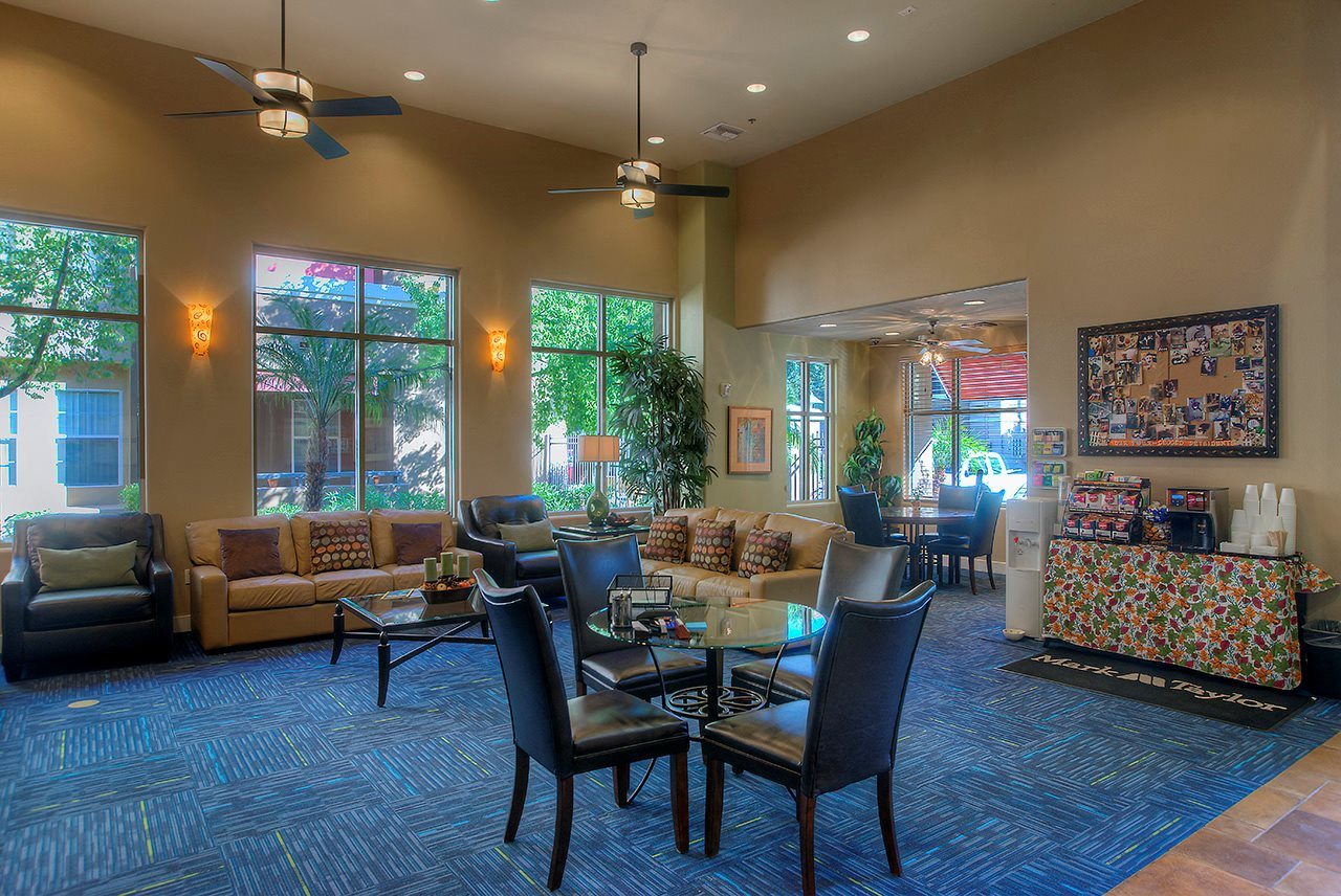 a living room with couches and chairs and a table