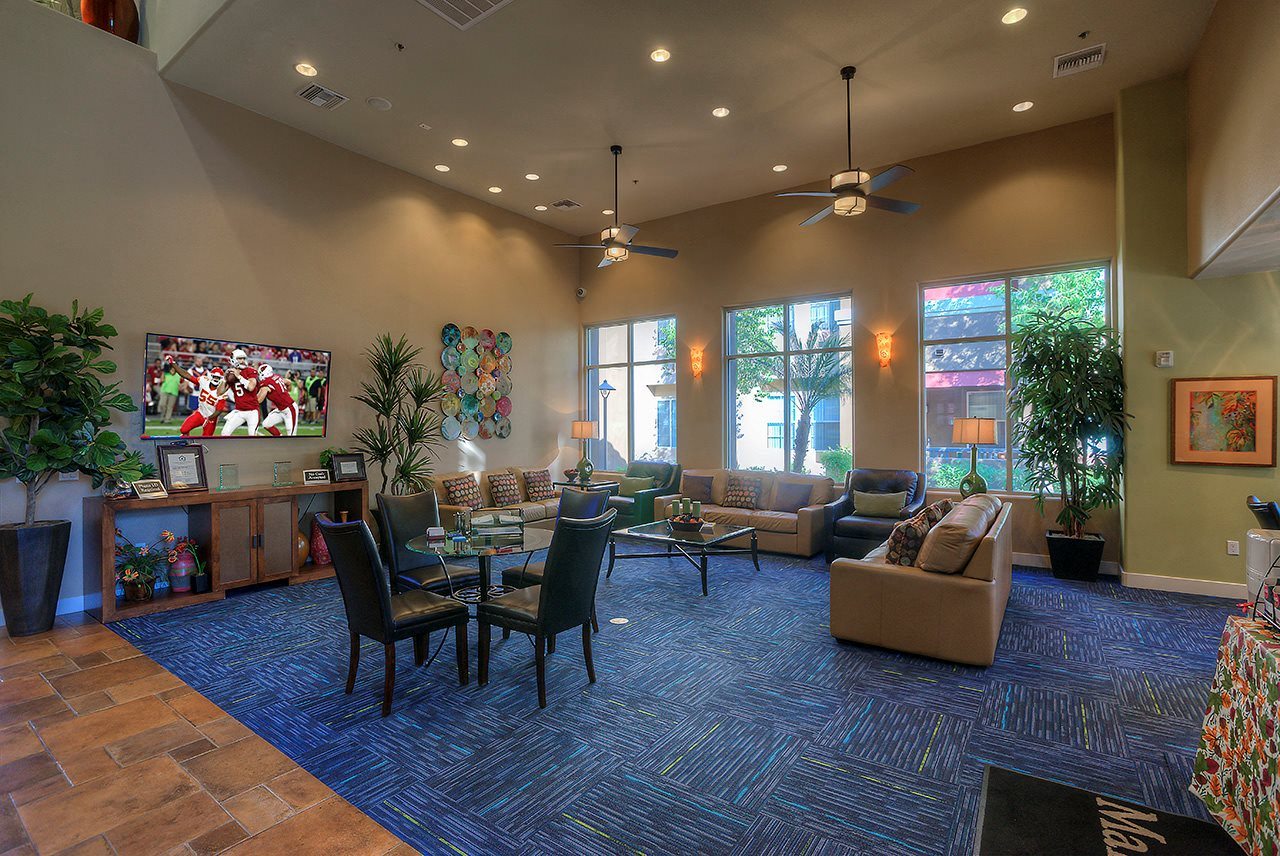 a living room with couches and chairs and a table