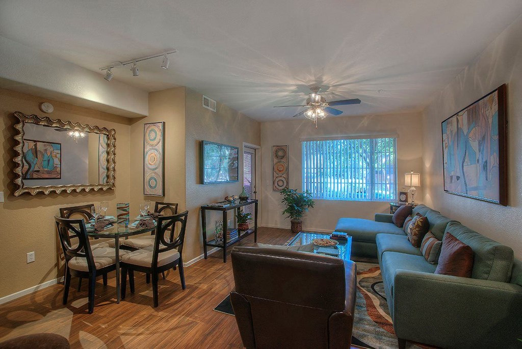 a living room with a couch and a table and a ceiling fan