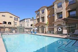 a large swimming pool in front of some apartment buildings