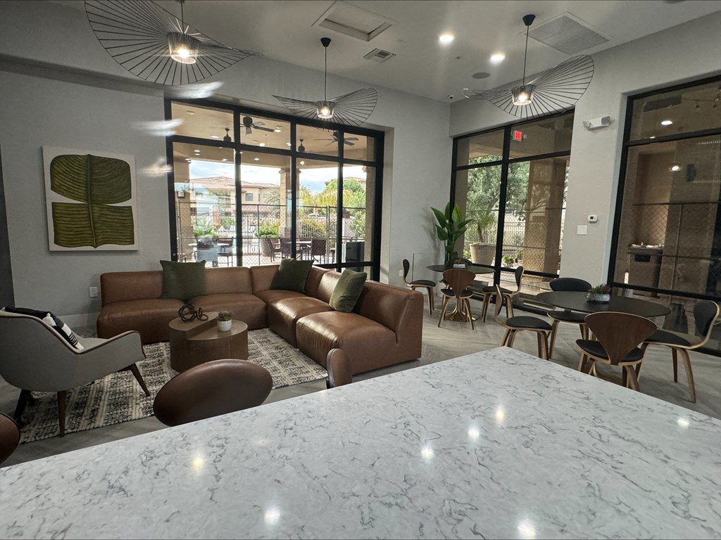a lobby of a hotel with couches and tables and chairs