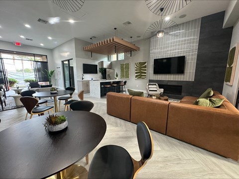 a living room and dining room with couches and tables