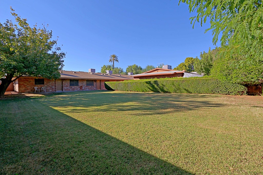 a house with a green lawn and a yard in front of it