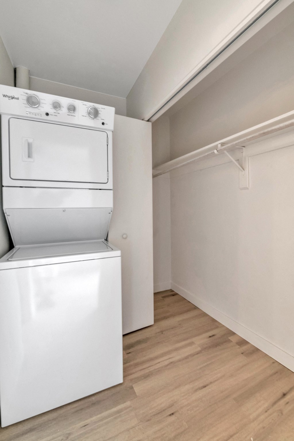 a white washer and dryer in a room with a wood floor and white