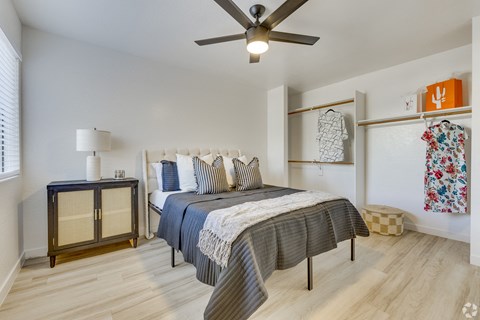 a bedroom with a bed and a ceiling fan