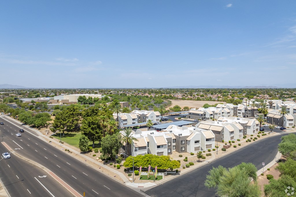 an aerial view of a suburb of houses and a highway