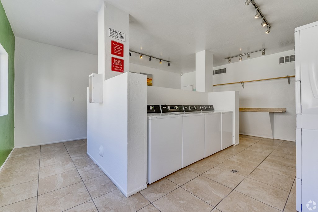 a kitchen with white appliances and a counter with a stove and a refrigerator