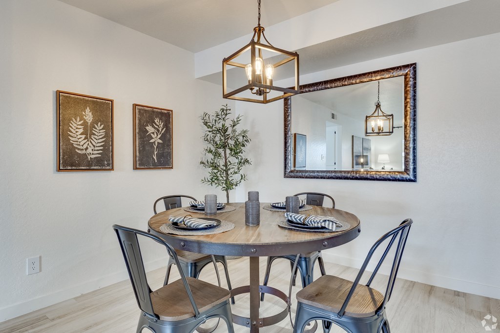 the dining room of a house with a table and chairs