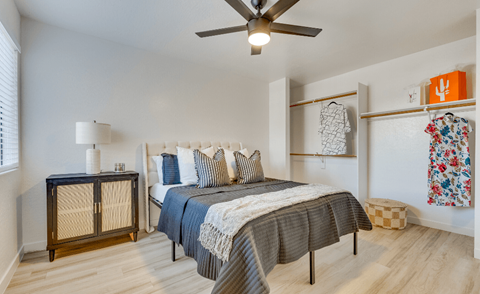a bedroom with a bed and a ceiling fan