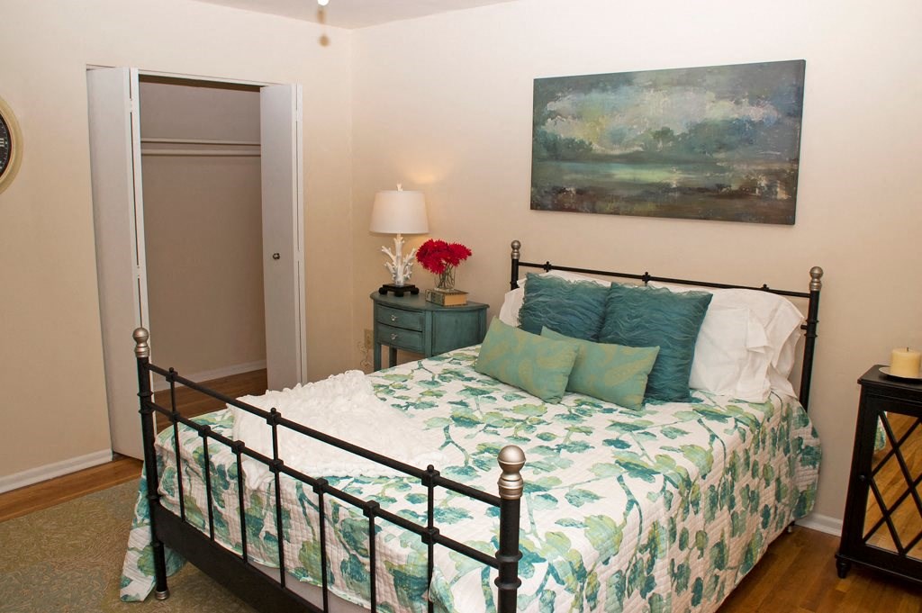 bedroom with bed, nightstand, and closet at ridgecrest village in washington dc